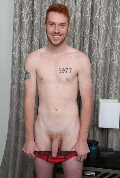 Redheaded gay hottie Sebastian Hunt unveils his inked body and stiff penis